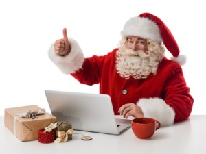 Santa Claus working with laptop on table Closeup Portrait. Isolated on White Background